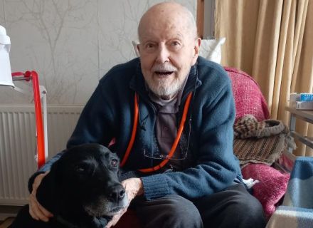 CPSS client stroking his black dog
